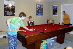 the boys learning to play pool